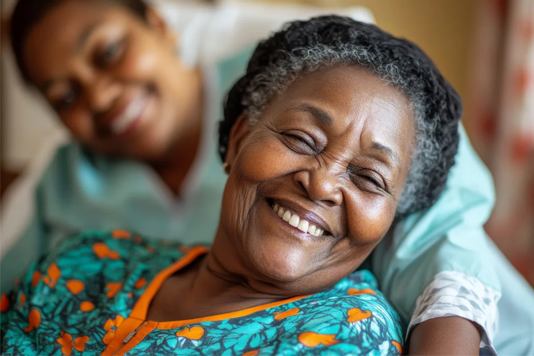 An older woman smiling while receiving compassionate hospice care